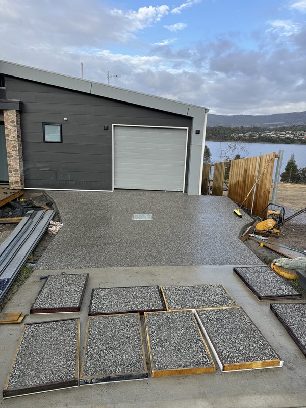 Exposed aggregate test panels laid out on the ground before the driveway pour.