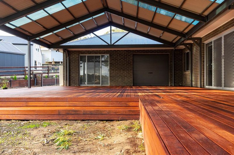 Deck under a gable patio roof