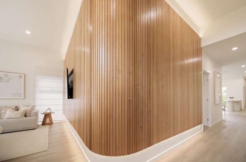 Curved timber slat feature wall with recessed TV